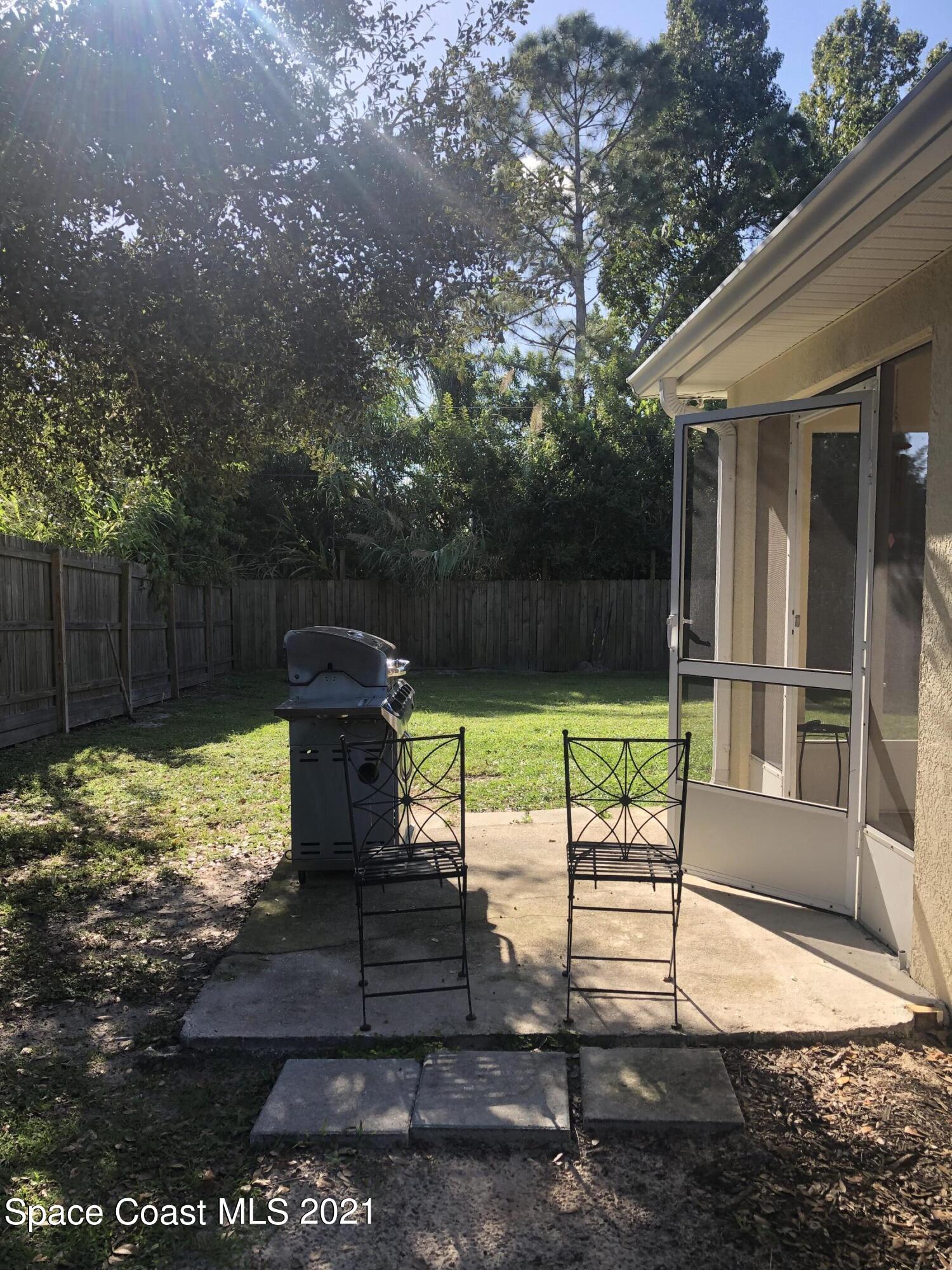 2865 Digby Road Southeast Palm Bay, FL 32909 - Photo 40 of 42 a view of a garden with a bench in the patio