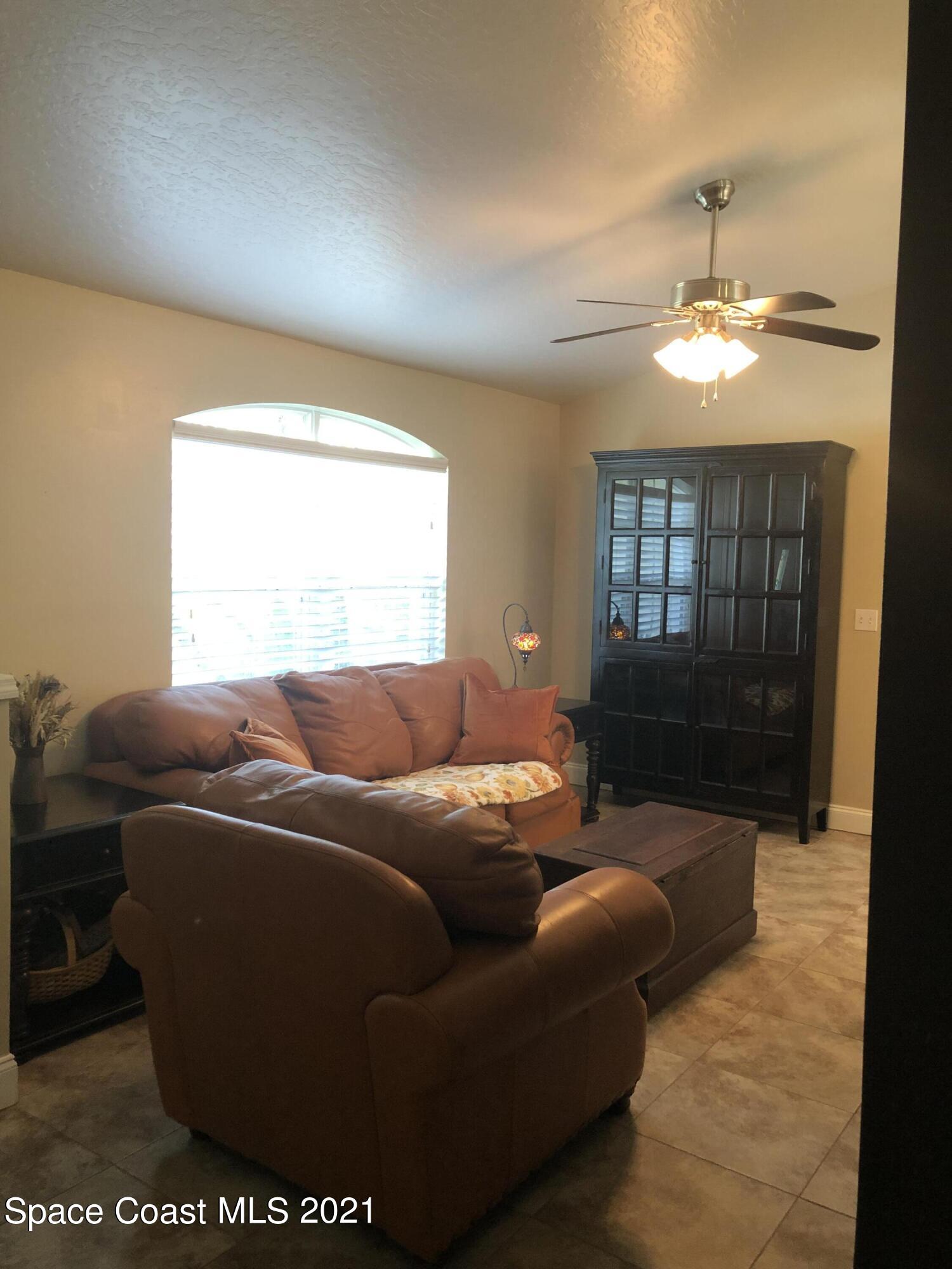 2865 Digby Road Southeast Palm Bay, FL 32909 - Photo 5 of 42 a living room with furniture and a chandelier