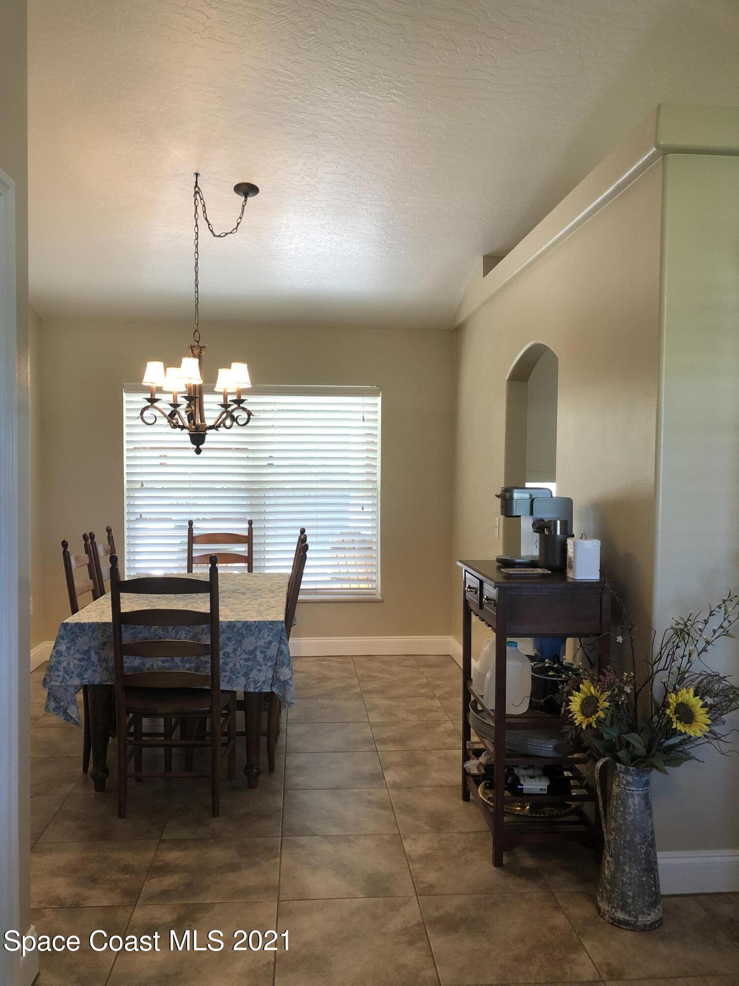 2865 Digby Road Southeast Palm Bay, FL 32909 - Photo 7 of 42 a dining room with furniture and window