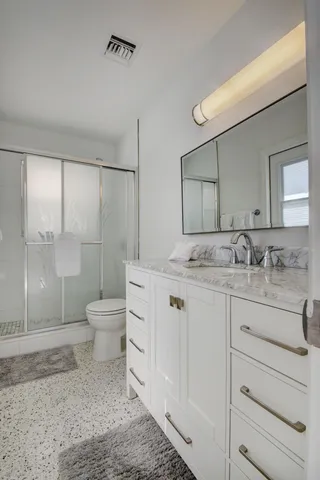 a living room with furniture and a view of kitchen