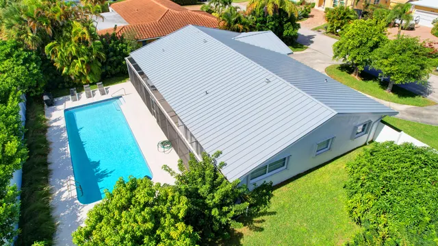 an aerial view of a house with a garden and plants