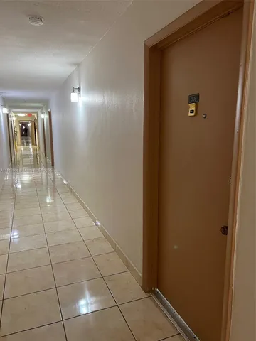 a front view of building with cars parked