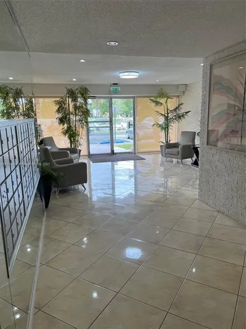 a lobby with furniture and floor to ceiling window