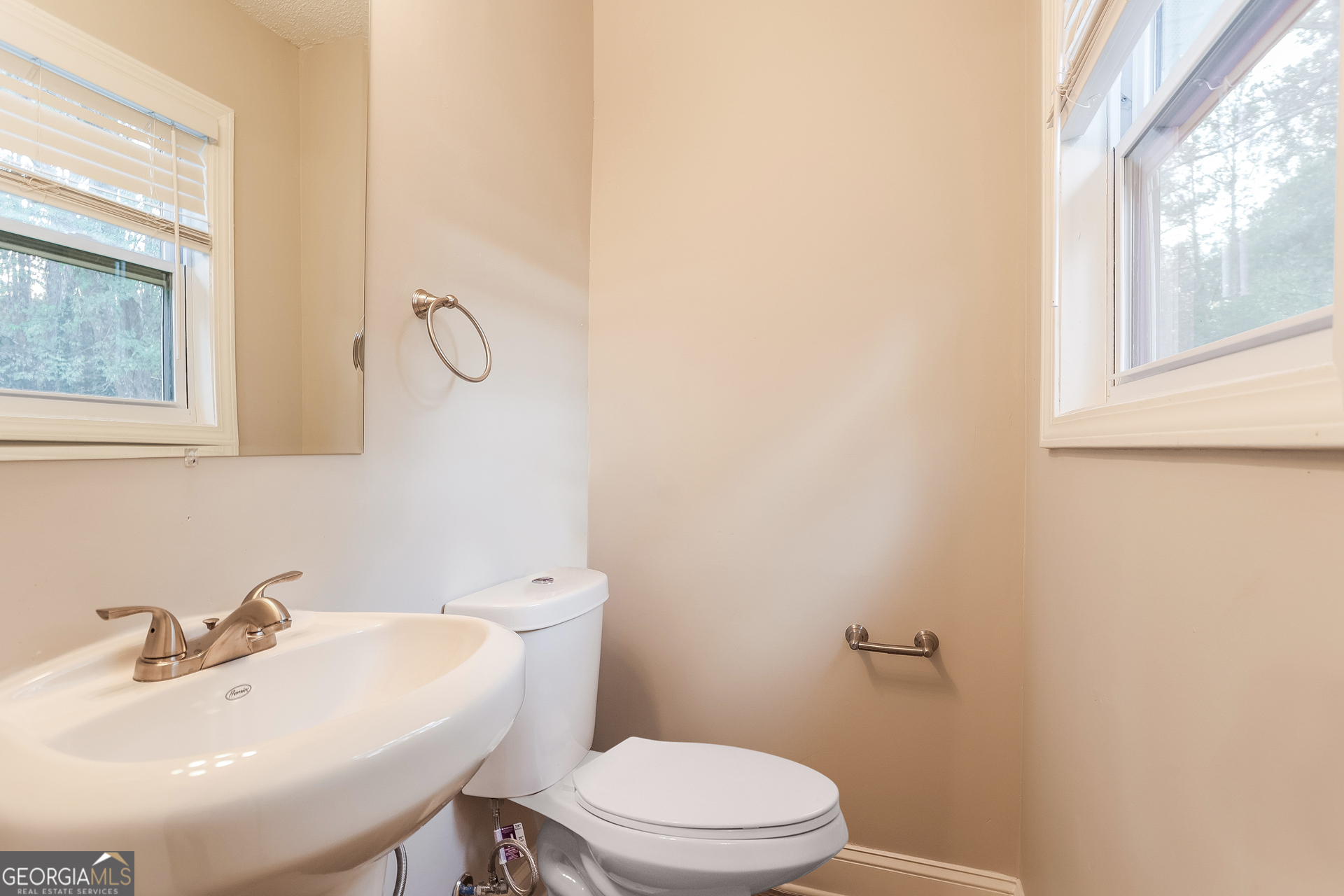 8621 Chestnut Lane Lithia Springs, GA 30122 - Photo 13 of 16 a bathroom with a sink a toilet and a window