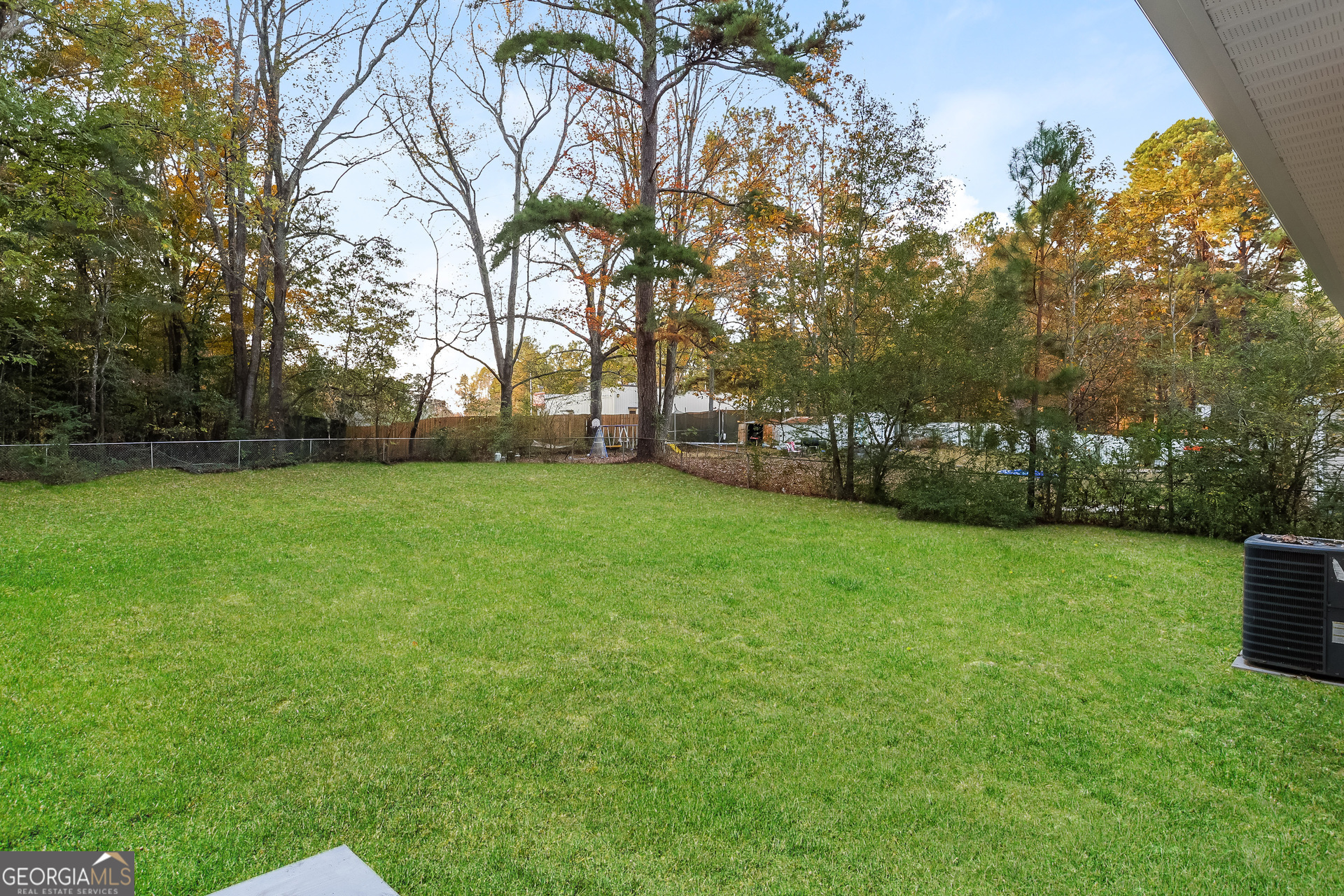 8621 Chestnut Lane Lithia Springs, GA 30122 - Photo 16 of 16 a view of a field of grass and trees