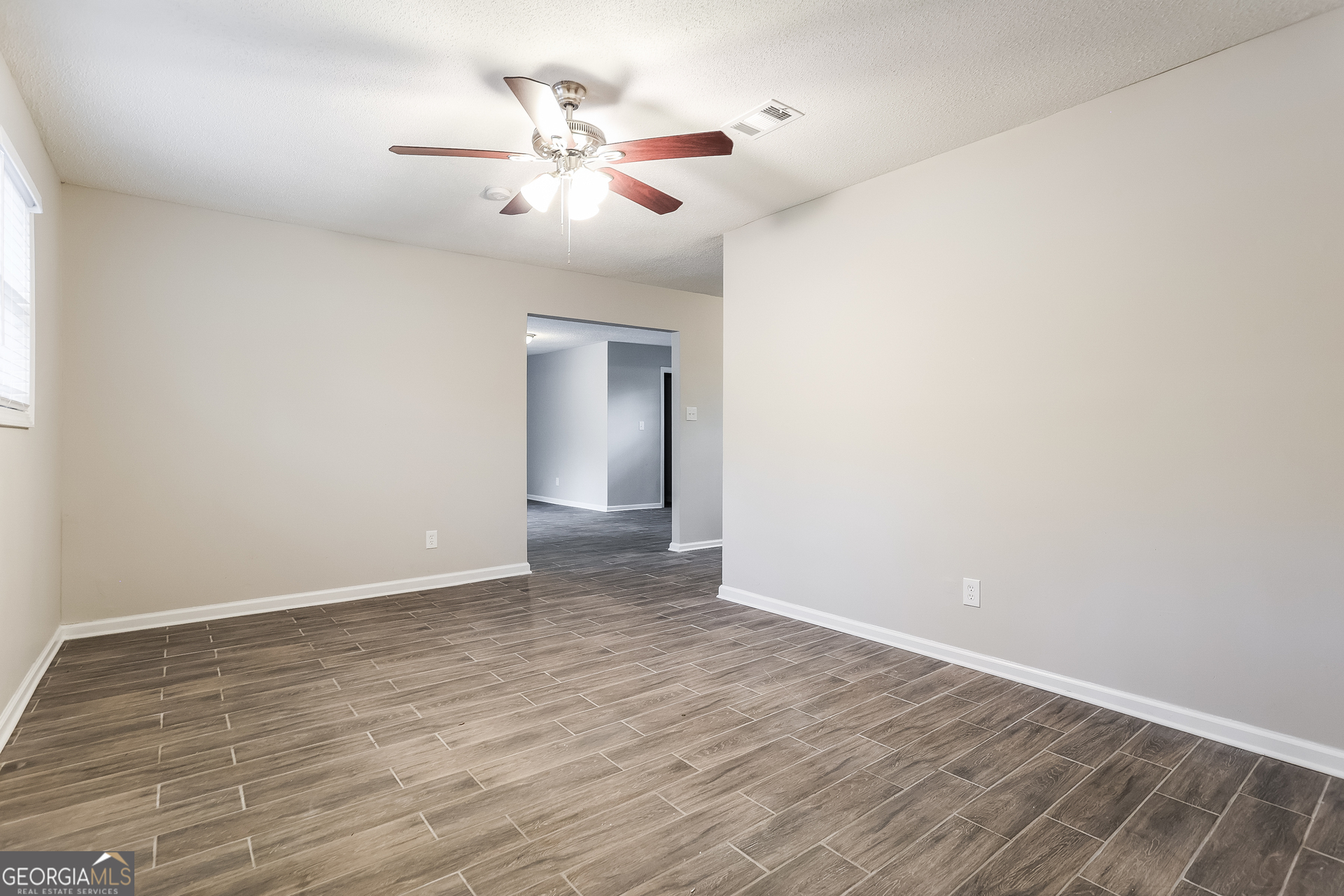 8621 Chestnut Lane Lithia Springs, GA 30122 - Photo 4 of 16 wooden floor in an empty room