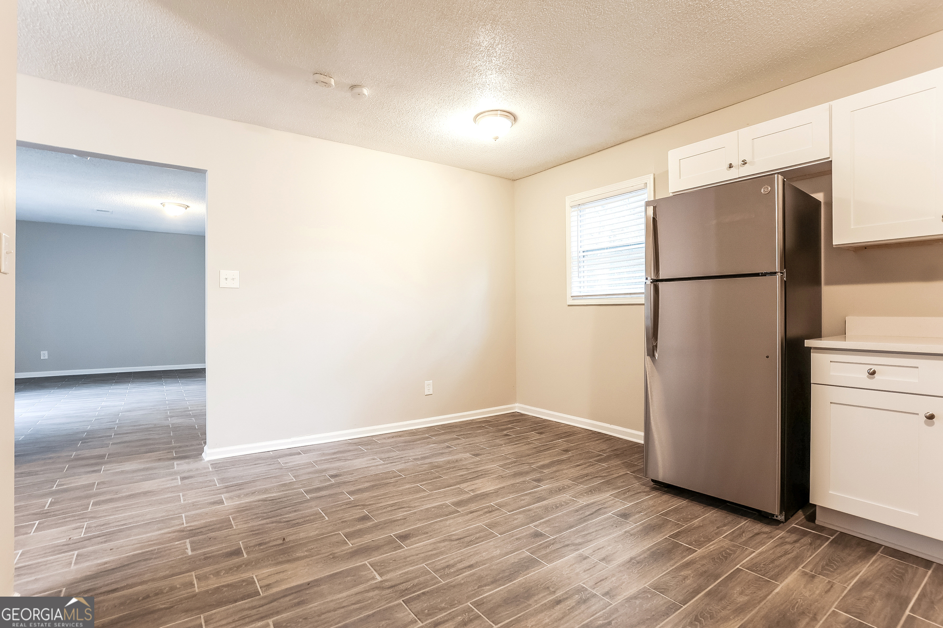 8621 Chestnut Lane Lithia Springs, GA 30122 - Photo 6 of 16 a view of a kitchen with a refrigerator and a microwave