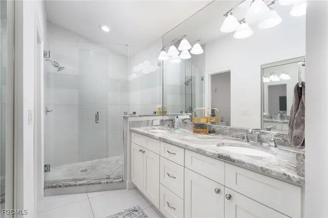 a bathroom with double sink and a mirror