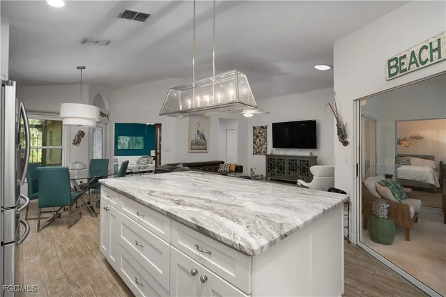 a kitchen with granite countertop a sink and a stove in it