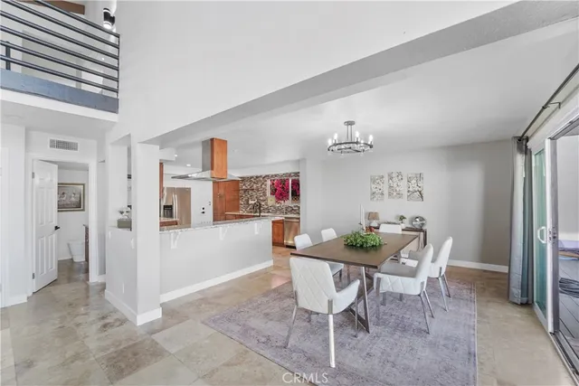 a view of a livingroom with furniture and a dining table