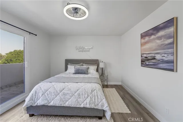 a bedroom with a bed and a painting on the wall