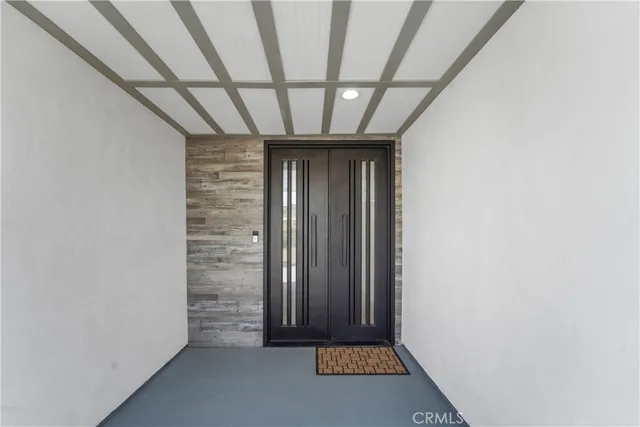 a view of an entryway with wooden floor and door