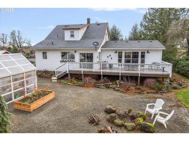 a view of a house with a yard and sitting area
