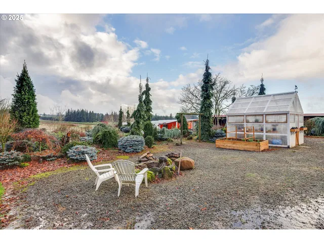 a view of a entrance gate of the house and trees