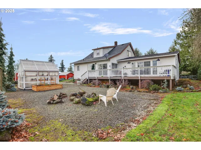 a backyard of a house with table and chairs
