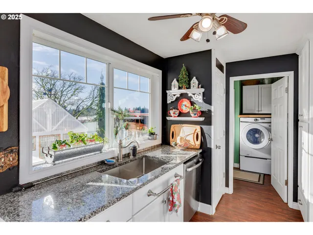 a living room with furniture a flat screen tv and a floor to ceiling window