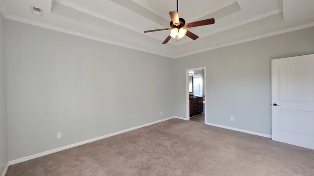 wooden floor in an empty room with a chandelier fan