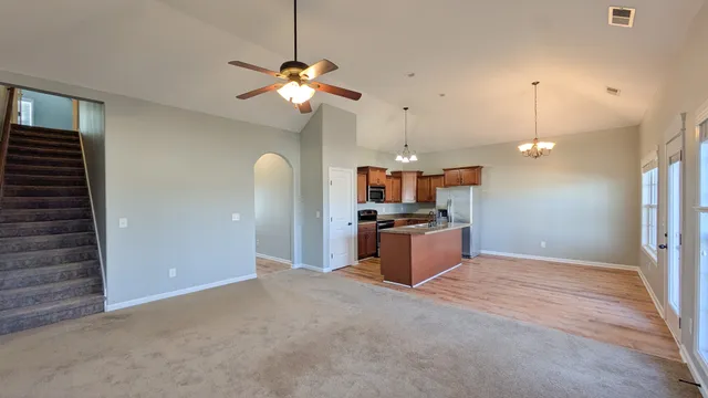a kitchen with stainless steel appliances kitchen island a refrigerator and a sink