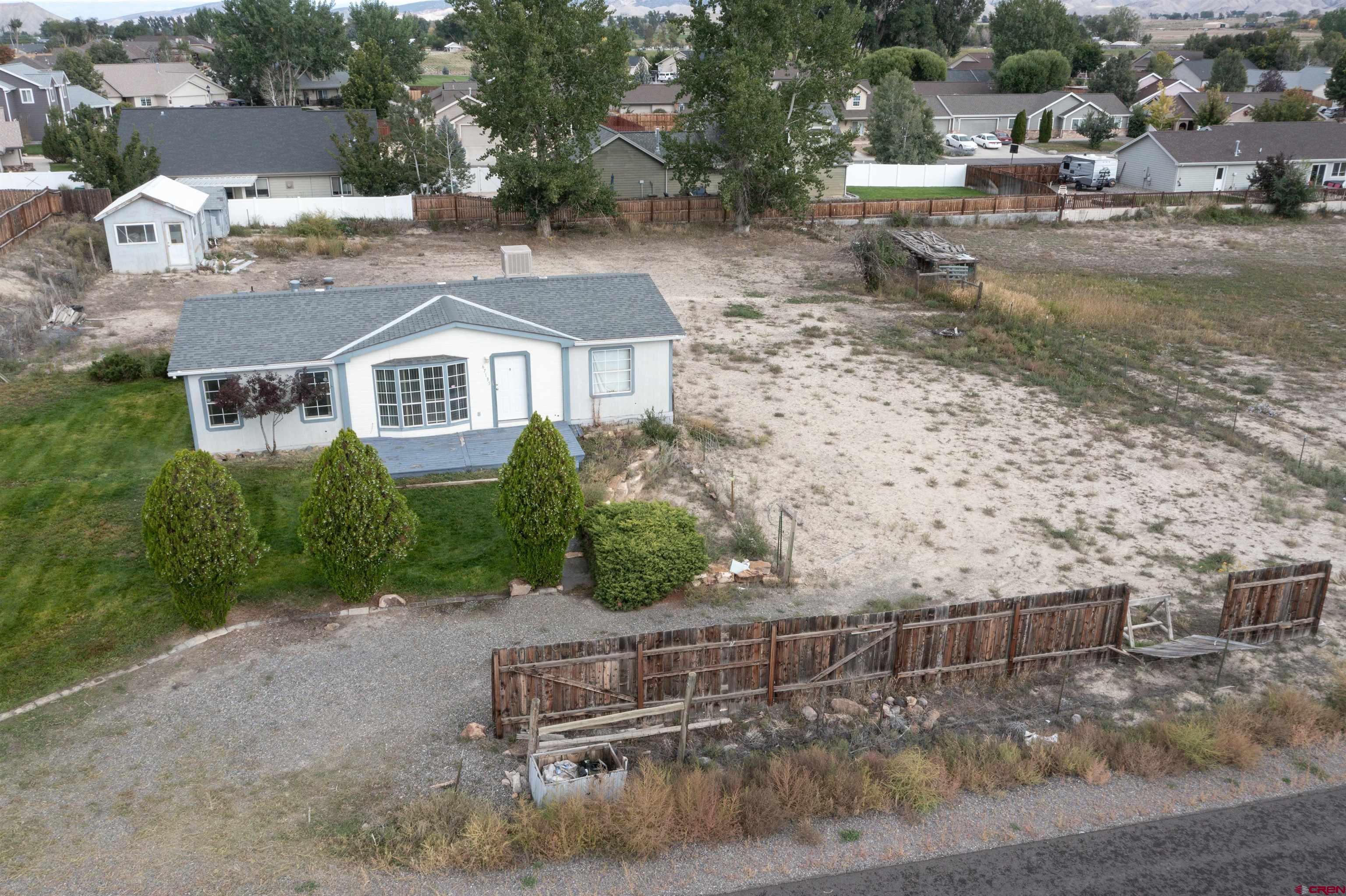 67135 N Road Montrose, CO 81401 - Photo 1 of 33 a view of a chairs and table in backyard
