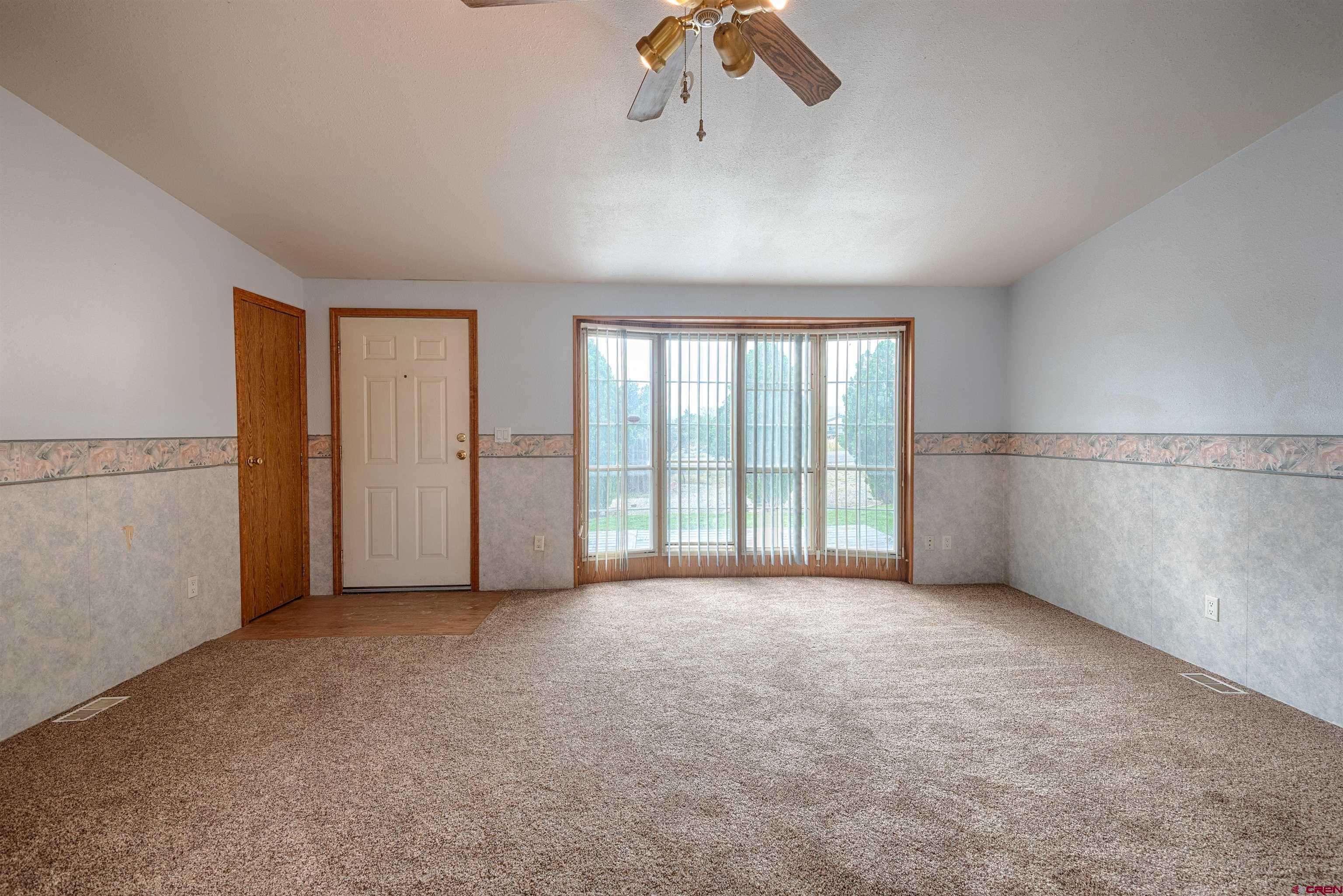 67135 N Road Montrose, CO 81401 - Photo 17 of 33 an empty room with windows and closet