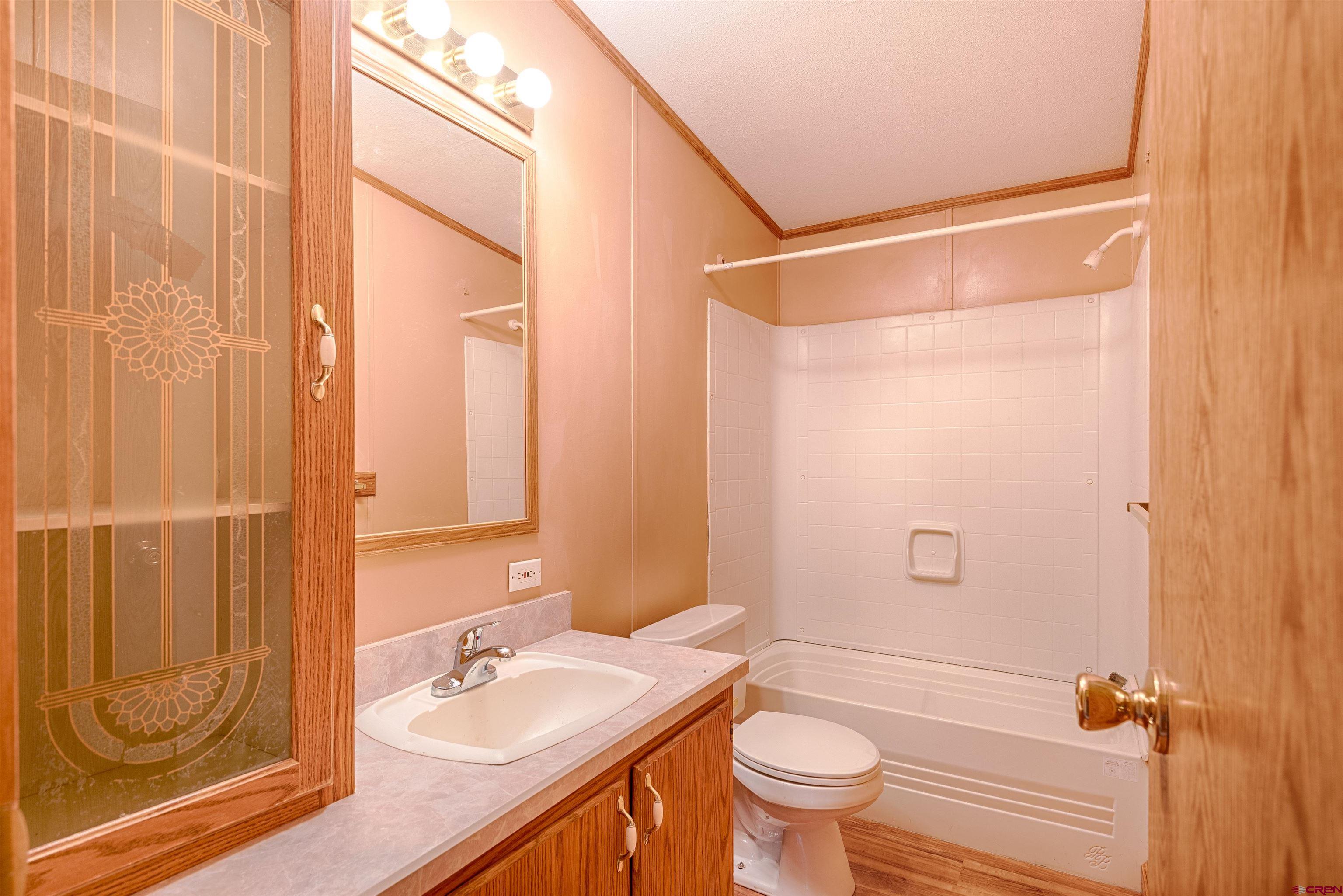 67135 N Road Montrose, CO 81401 - Photo 29 of 33 a bathroom with a sink a toilet and shower