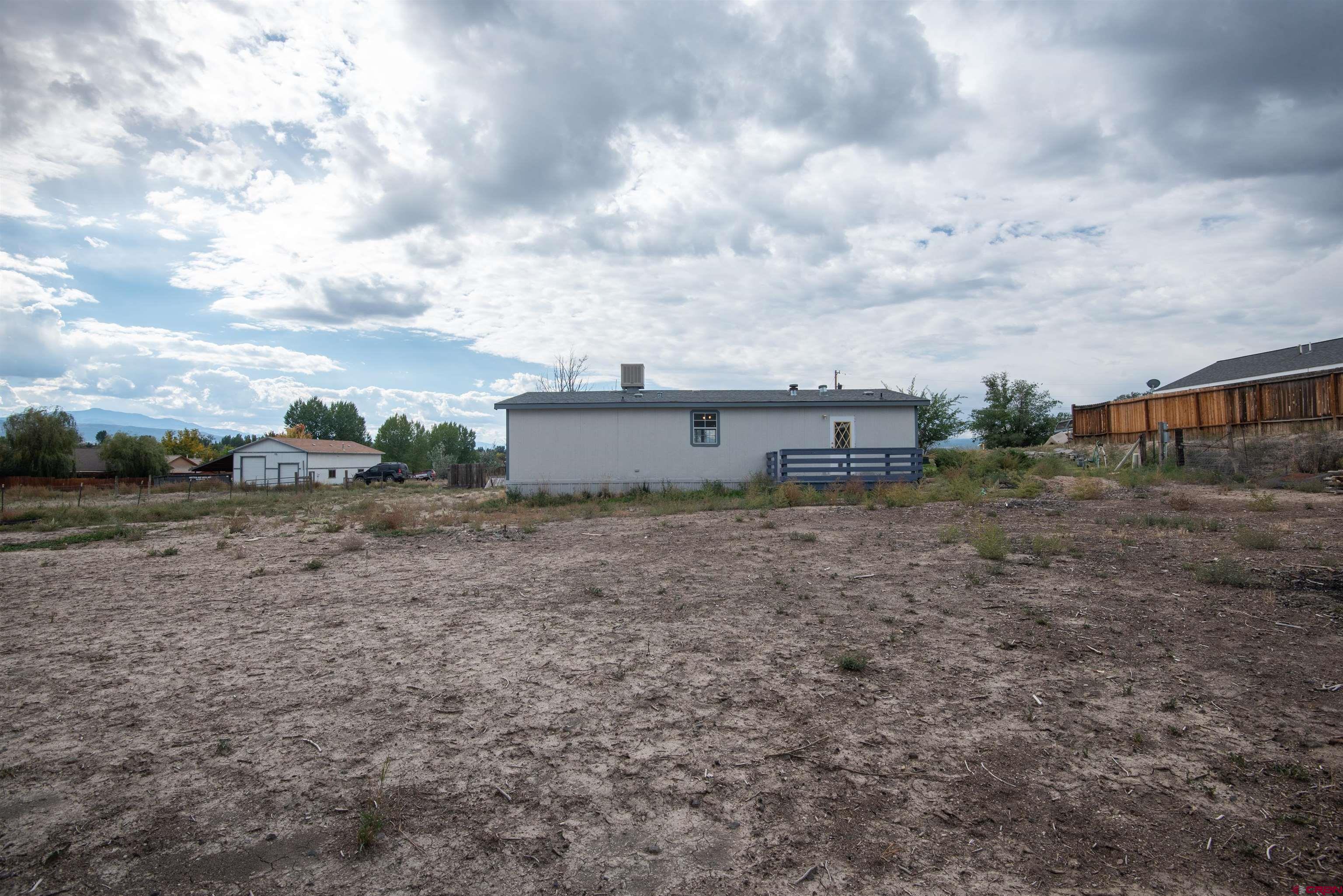 67135 N Road Montrose, CO 81401 - Photo 32 of 33 a view of a dry yard with wooden fence