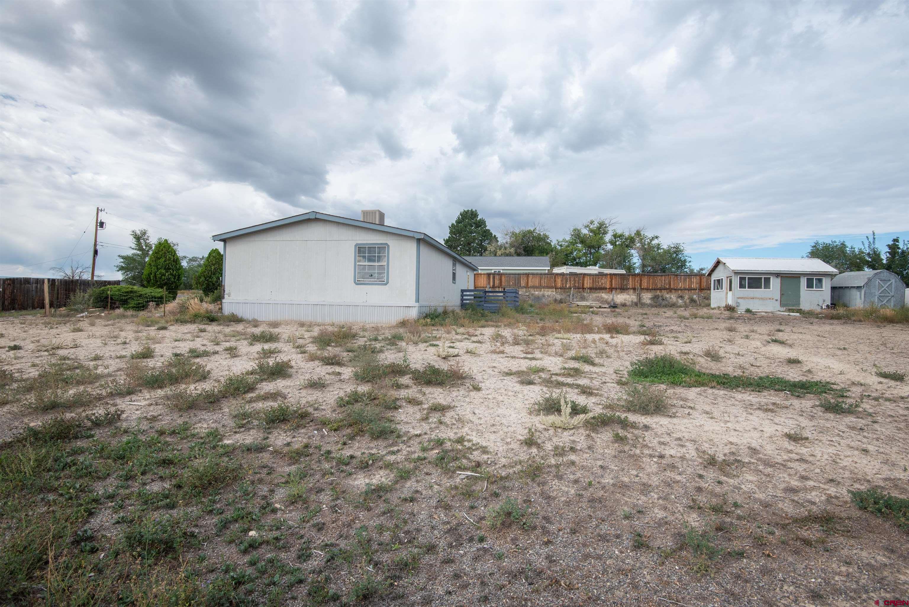 67135 N Road Montrose, CO 81401 - Photo 33 of 33 a view of a dry yard with wooden fence