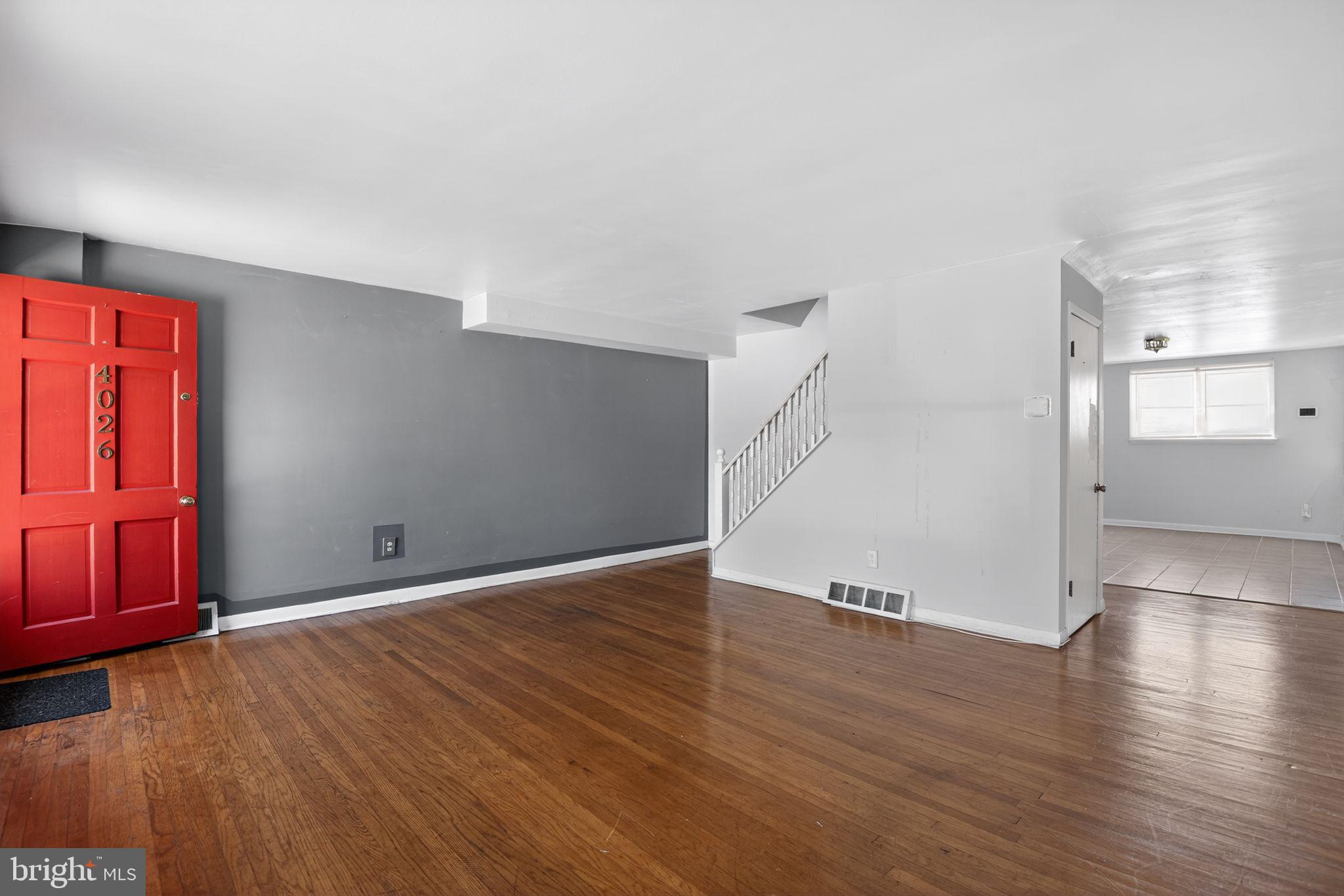 Bright entryway with bold red door.
