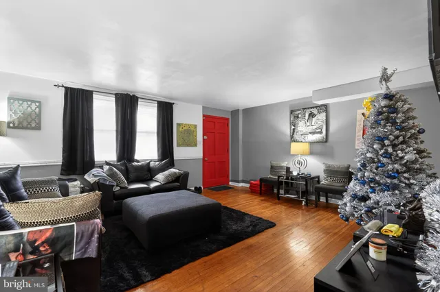a living room with furniture and a christmas tree