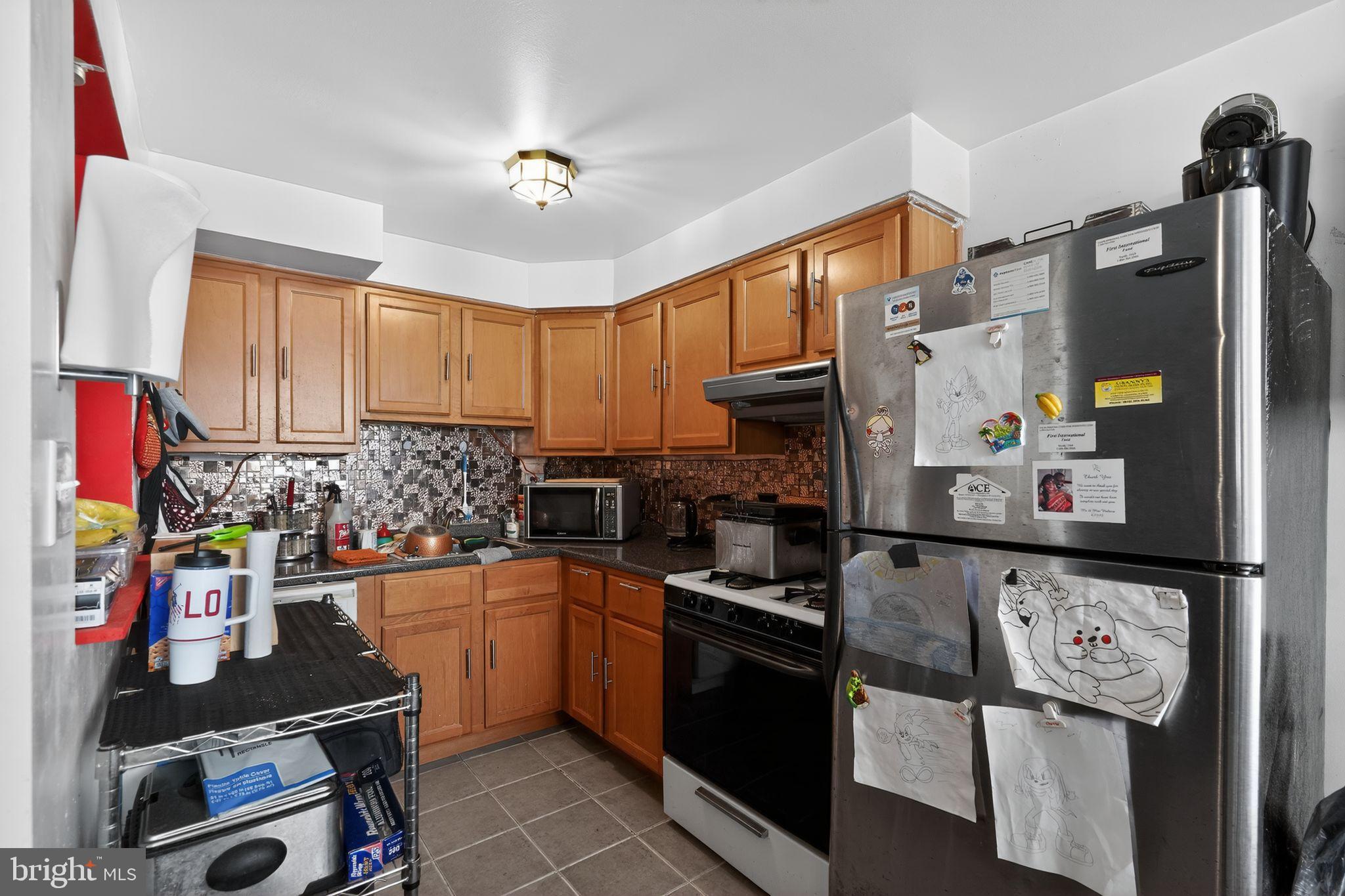 4026 Gideon Road Brookhaven, PA 19015 - Photo 6 of 28 a kitchen with refrigerator and cabinets