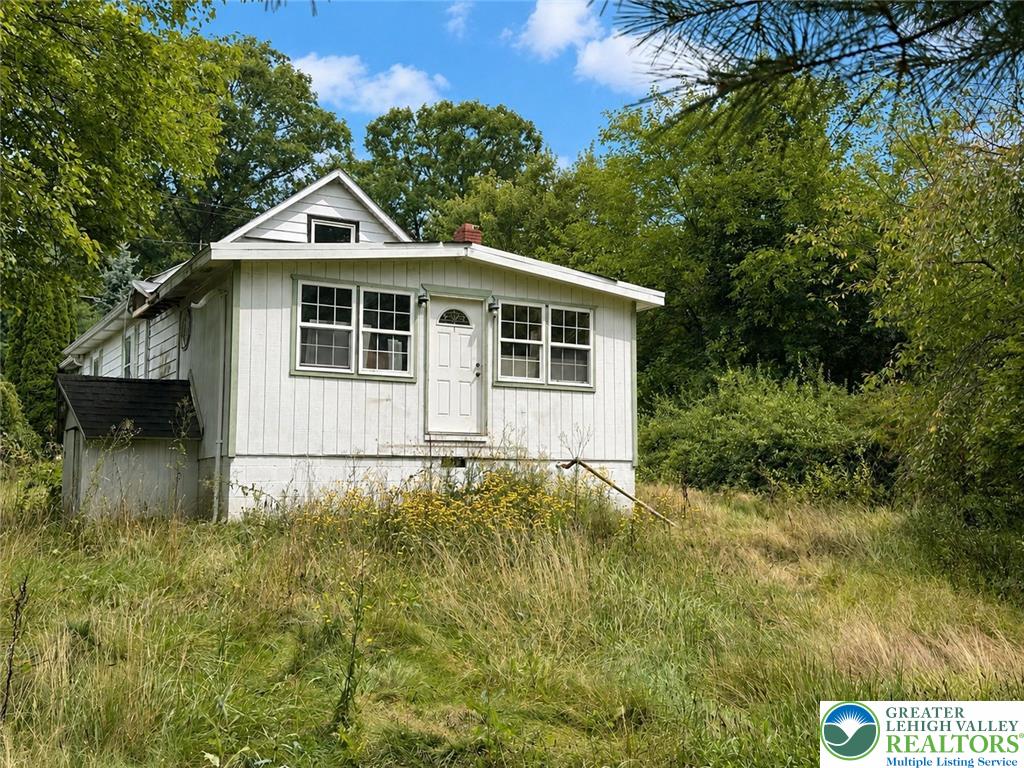 3540 Mountain Road, Unit 3538 Slatington, PA 18080 - Photo 3 of 27 A classic cottage stands nestled among mature trees on a sprawling grassy lot.