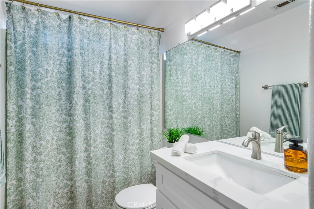 16366 West Sun Canyon Street Riverside, CA 92503 - Photo 15 of 21 a bathroom with a sink and a mirror