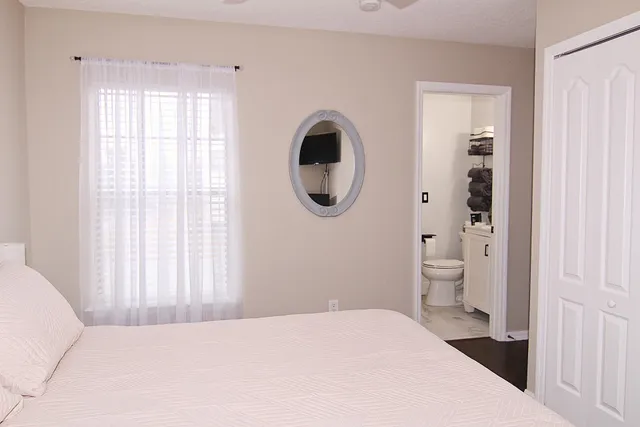 a bedroom with a bed and a chandelier