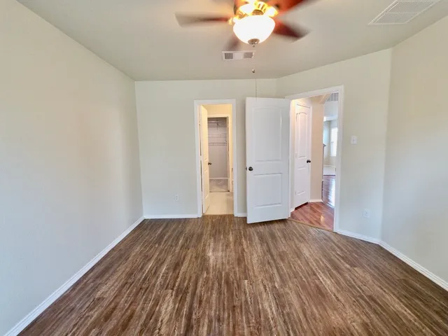 a view of a room with wooden floor