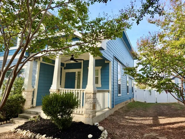 front view of a house with a tree