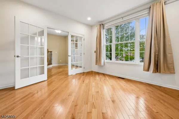 an empty room with windows and closet