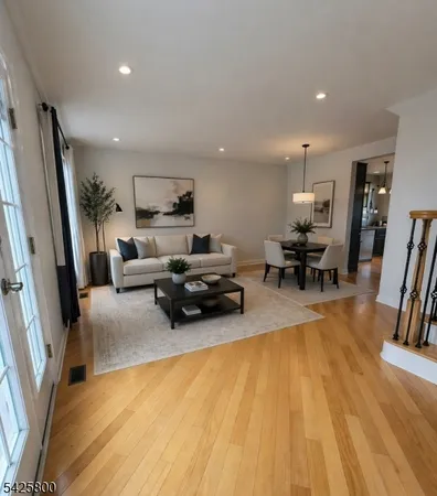 an empty room with wooden floor and stairs