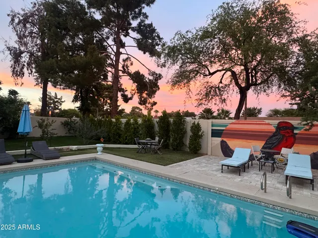 a backyard of a house with table and chairs