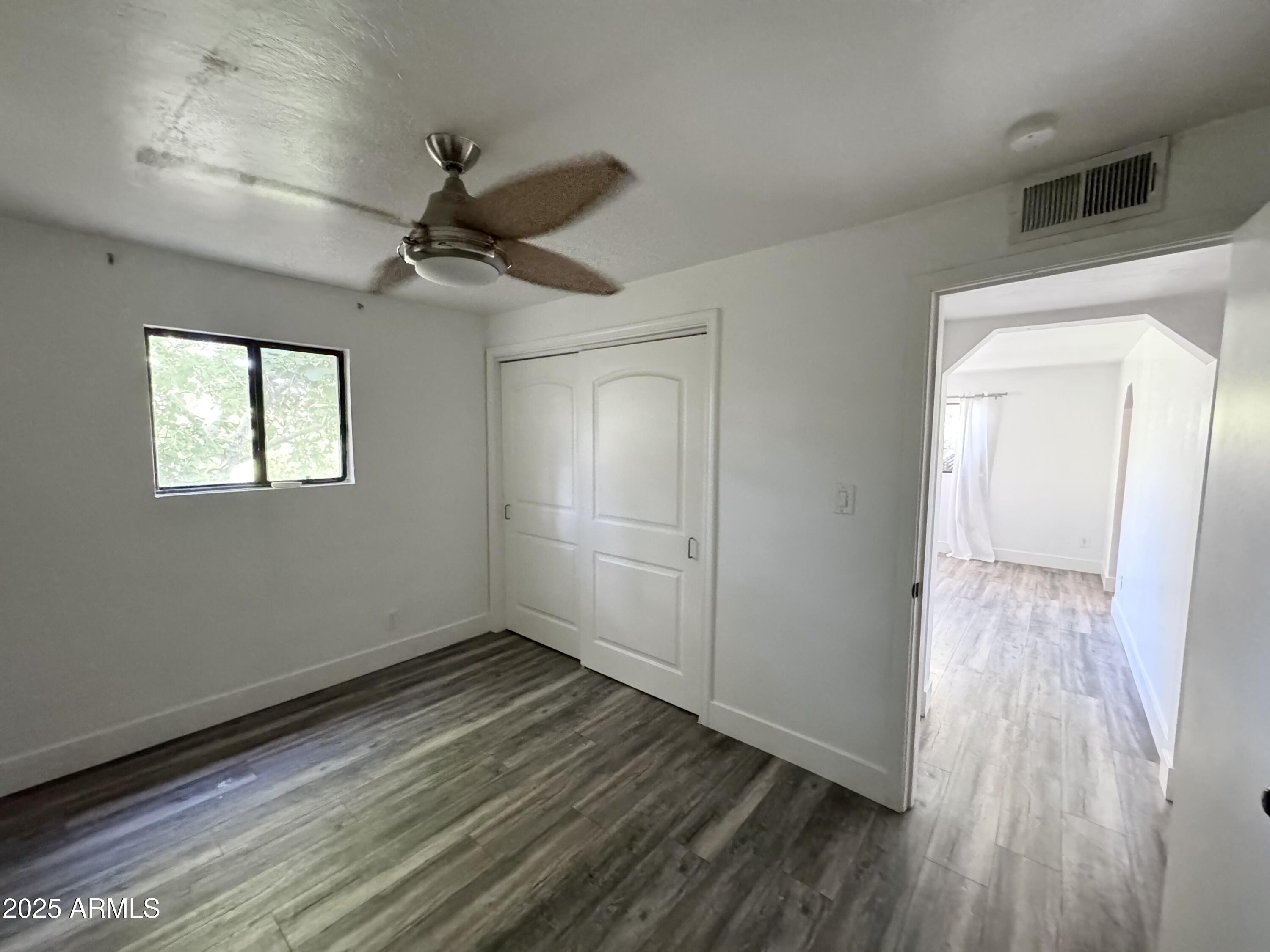 3134 North 28th Street Phoenix, AZ 85016 - Photo 17 of 21 a view of empty room with wooden floor