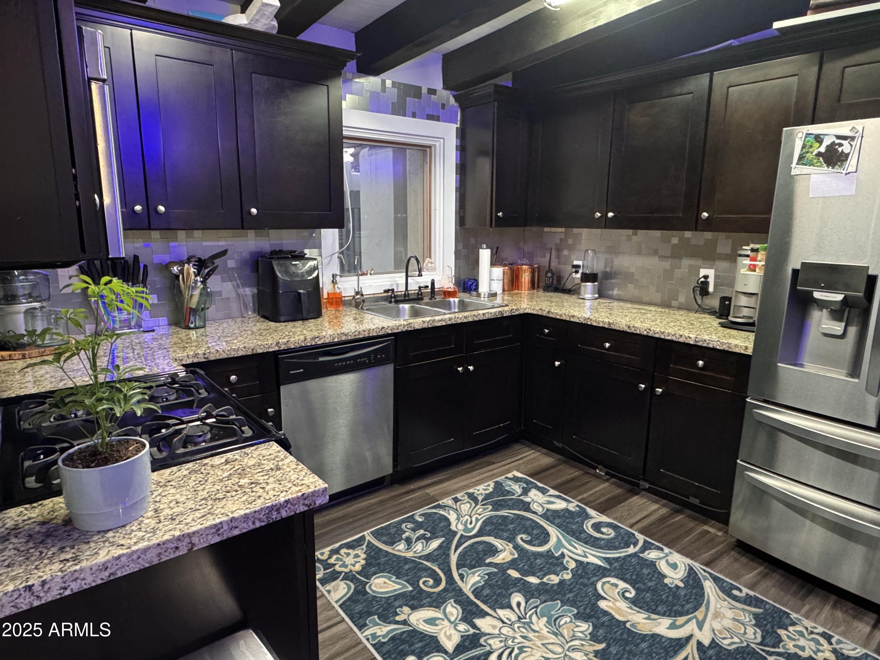 3134 North 28th Street Phoenix, AZ 85016 - Photo 3 of 21 a kitchen with a sink and cabinets