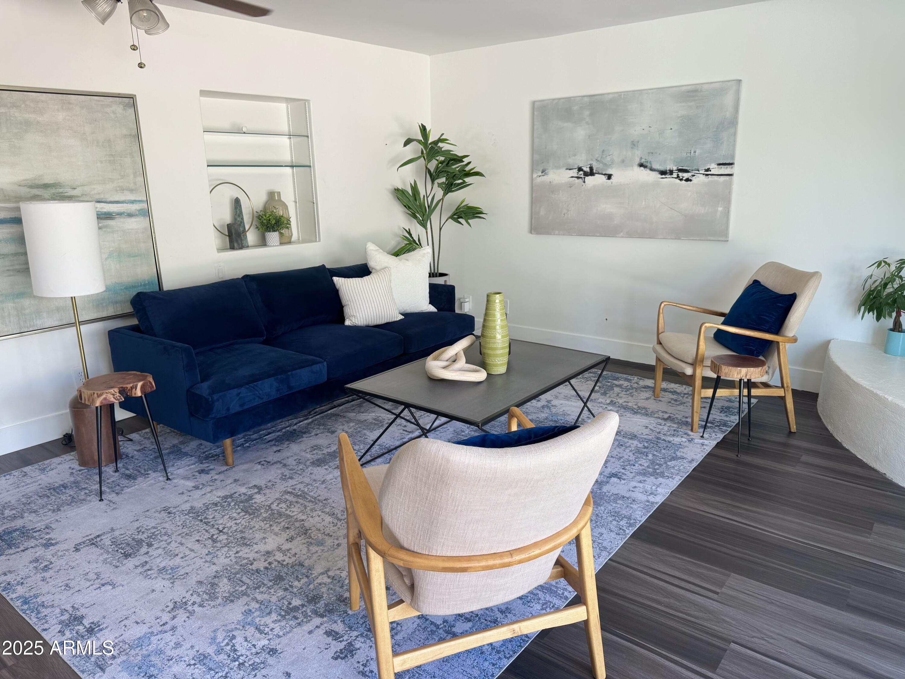 3134 North 28th Street Phoenix, AZ 85016 - Photo 8 of 21 a living room with furniture a wooden floor and next to a window