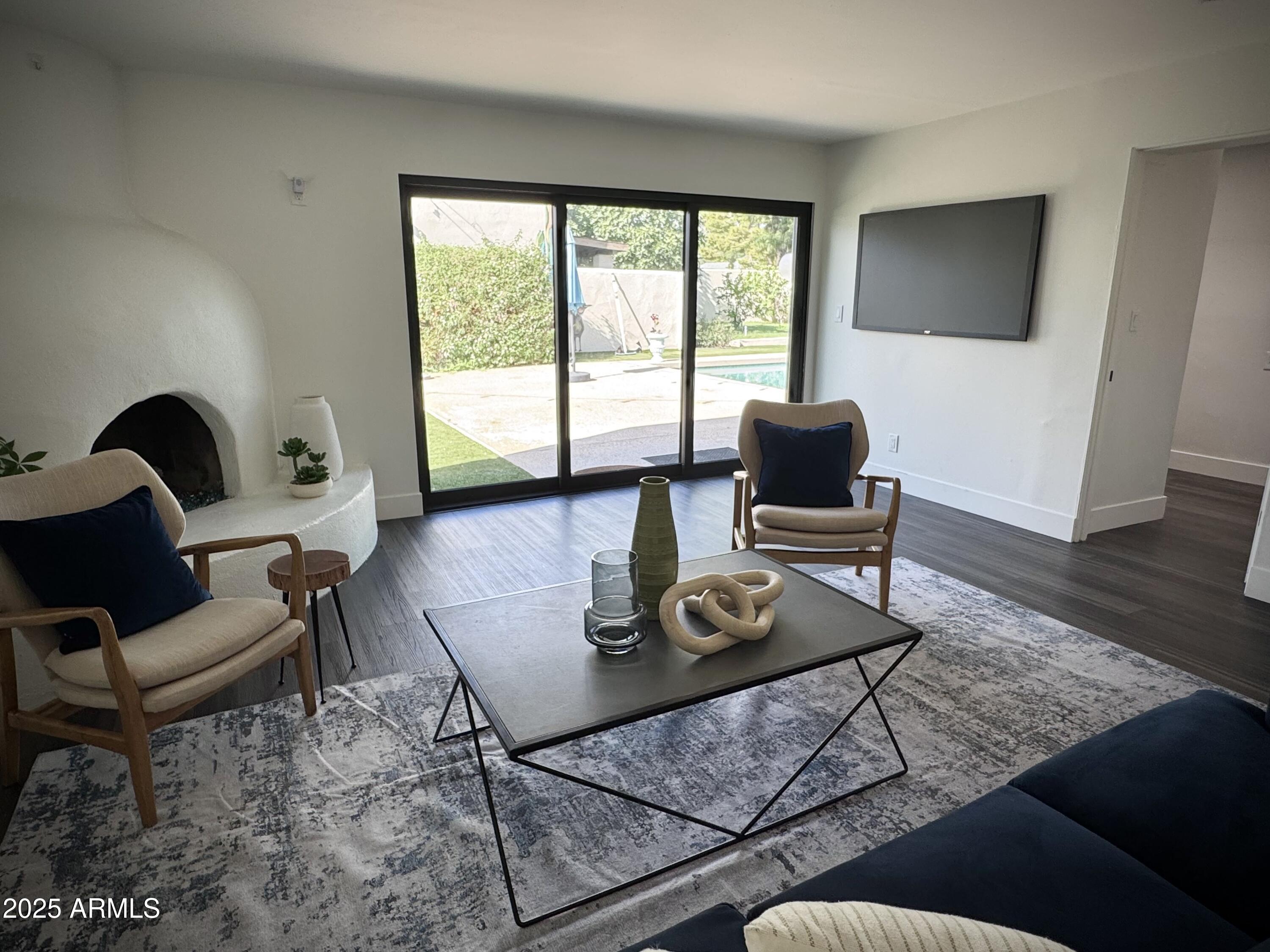 3134 North 28th Street Phoenix, AZ 85016 - Photo 9 of 21 a living room with furniture and a flat screen tv