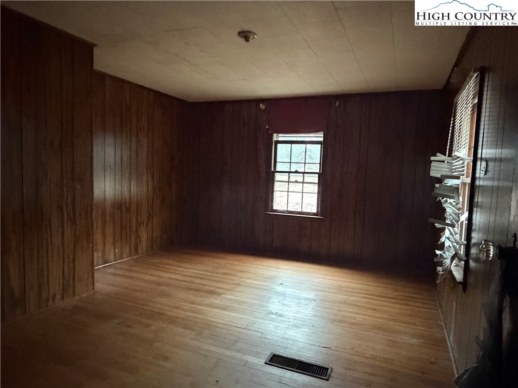 1630 Pleasant Ridge Road State Road, NC 28676 - Photo 12 of 17 an empty room with wooden floor and windows