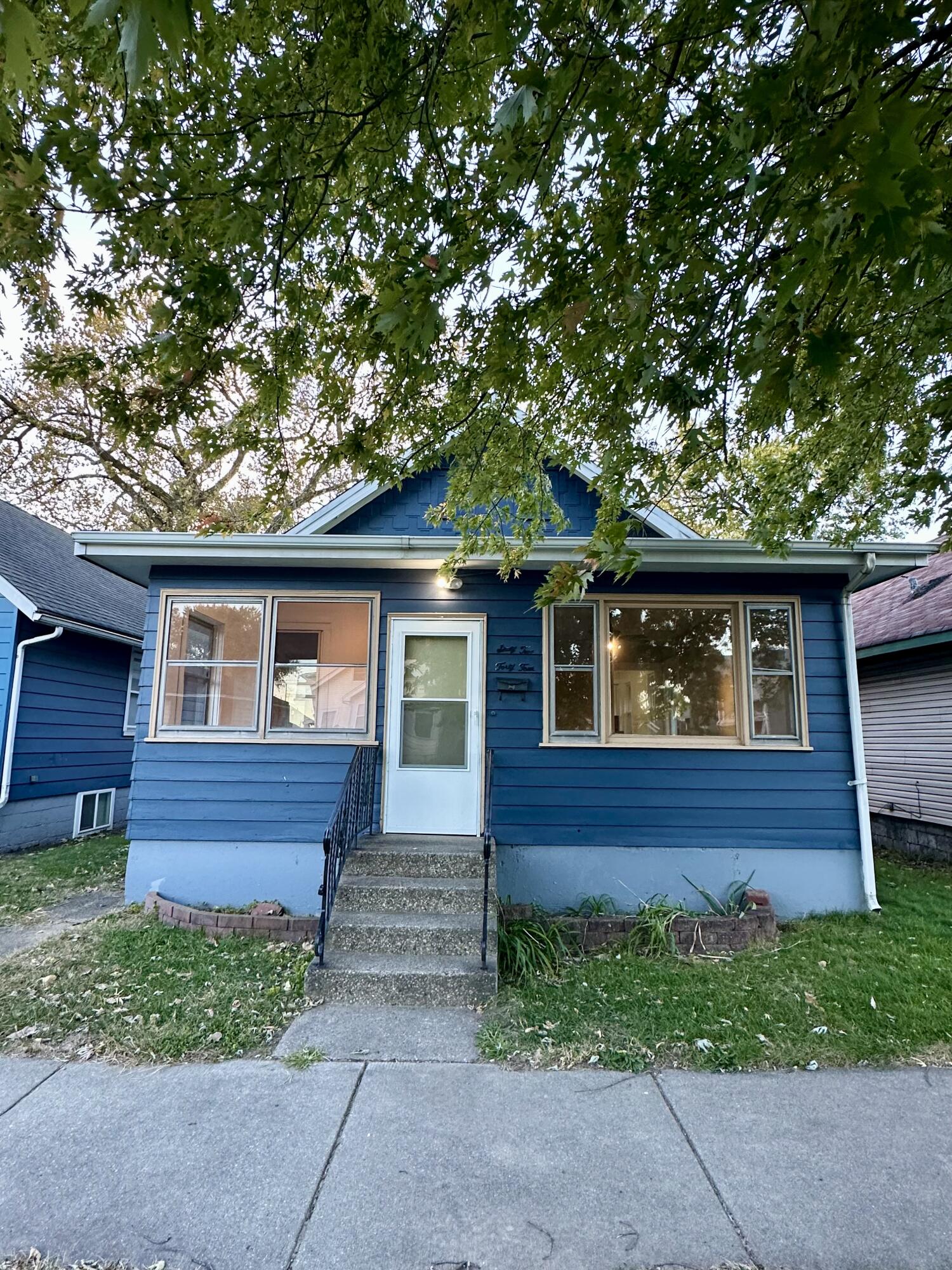 a front view of a house with a garden