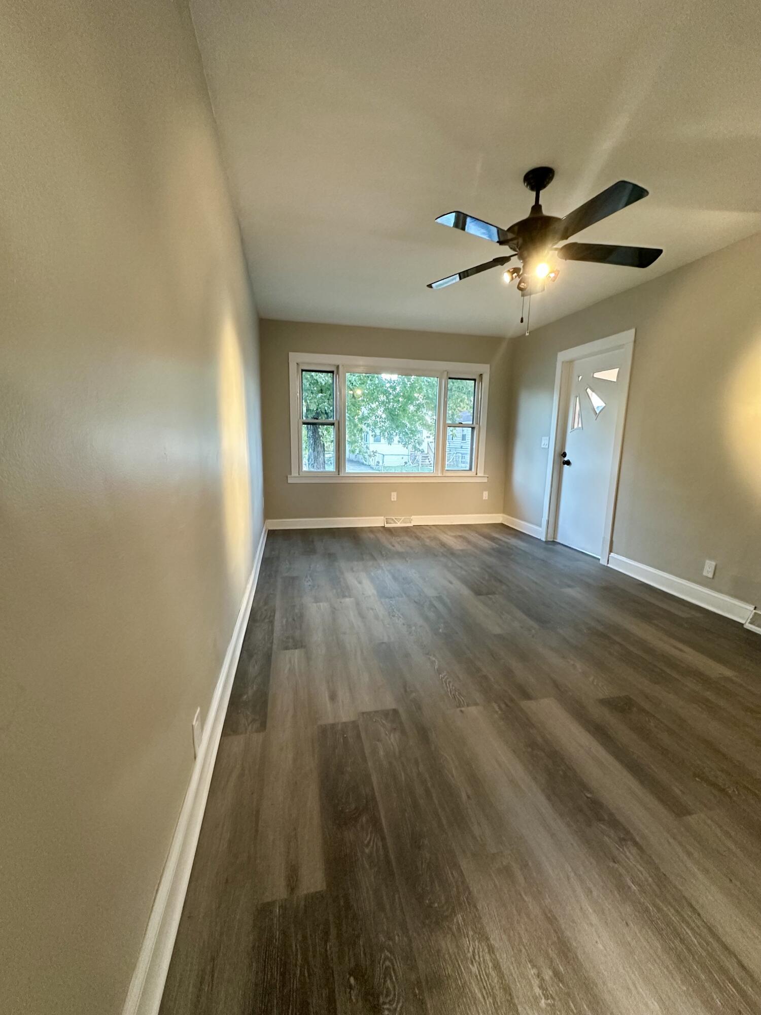 6244 Madison Avenue Hammond, IN 46324 - Photo 3 of 21 wooden floor in an empty room with a window