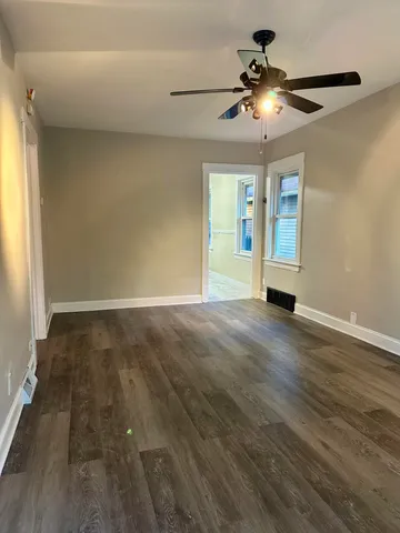 wooden floor in an empty room with a window