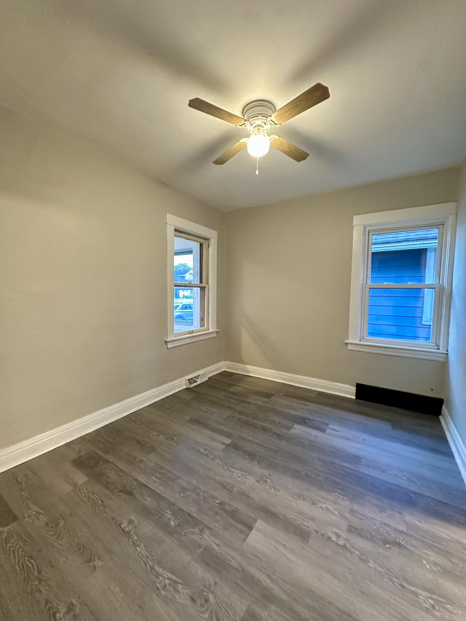 6244 Madison Avenue Hammond, IN 46324 - Photo 5 of 21 a view of an empty room with a window and wooden floor