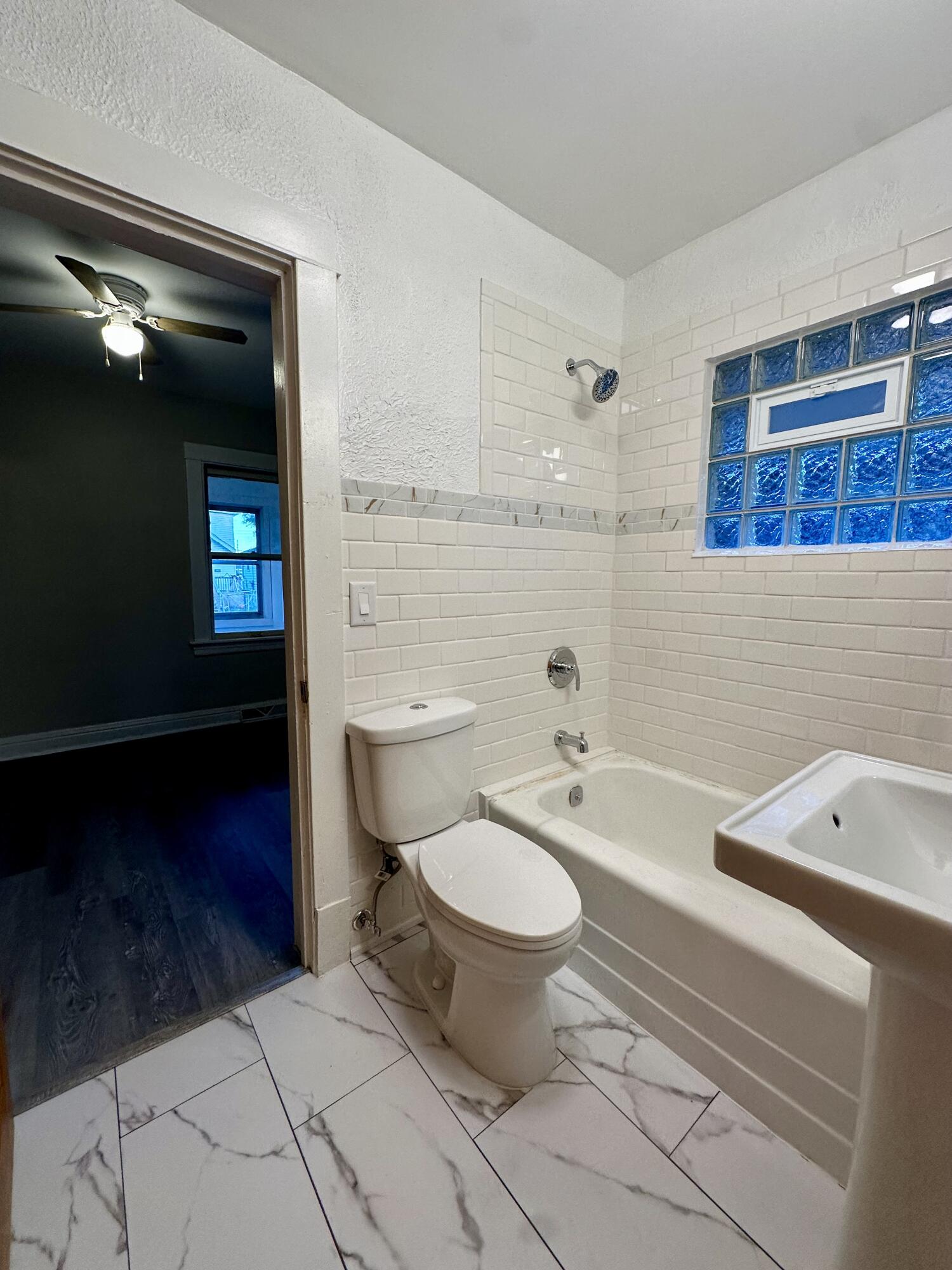 6244 Madison Avenue Hammond, IN 46324 - Photo 8 of 21 a bathroom with a toilet a sink and mirror