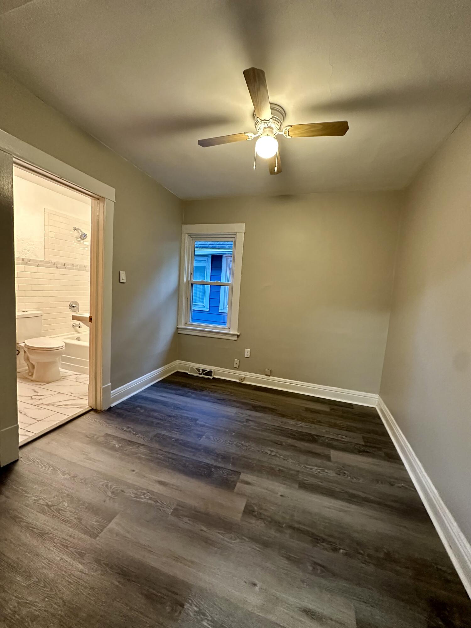 6244 Madison Avenue Hammond, IN 46324 - Photo 9 of 21 an empty room with wooden floor and windows