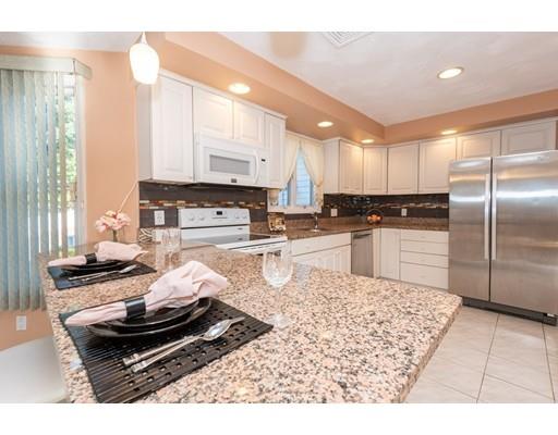 4 Rivers Lane Stoneham, MA 02180 - Photo 14 of 42 a kitchen with stainless steel appliances granite countertop a stove a sink and a refrigerator